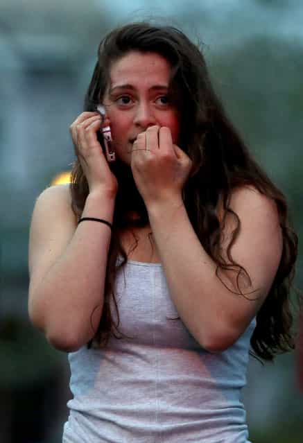 Resident Rosie Meyer, who said she heard gunshots, reacts while watching police respond on April 19, 2013 in Watertown, Massachusetts. After a car chase and shoot out with police, one suspect in the Boston Marathon bombing, Tamerlan Tsarnaev, 26, was shot and killed by police early morning April 19, and a manhunt is underway for his brother and second suspect, 19-year-old suspect Dzhokhar A. Tsarnaev. The two men, reportedly Chechen of origin, are suspects in the bombings at the Boston Marathon on April 15, that killed three people and wounded at least 170. (Photo by Mario Tama)
