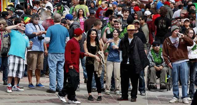 Crowds begin to gather at the Denver 4/20 pro-marijuana rally at Civic Center Park in Denver on Saturday, April 20, 2013. Authorities generally look the other way at public pot smoking here on April 20. Police said this week they're focused on crowd security in light of attacks that killed three at the finish line of the Boston Marathon. (Photo by Brennan Linsley/AP Photo)