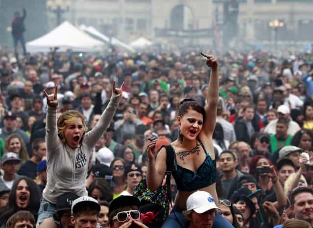 Members of a crowd numbering tens of thousands smoke marijuana and listen to live music, at the Denver 420 pro-marijuana rally at Civic Center Park in Denver on Saturday, April 20, 2013. Even before the passage in November 2012 of Colorado Amendment 64 promised the legalization of marijuana for recreational use, April 20th has for years been a celebration of marijuana counterculture, and the 2013 Denver rally draw larger crowds than previous years. (Photo by Brennan Linsley/AP Photo)