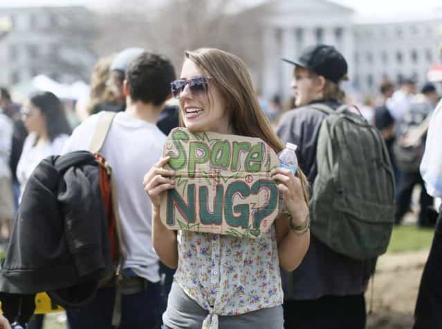 A woman holds a sign looking for donations at the 4/20 marijuana holiday in Civic Center Park in downtown Denver April 20, 2013. (Photo by Rick Wilking/Reuters)