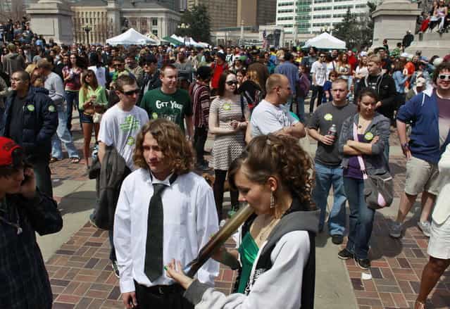 Youths smoke marijuana at the Denver 4/20 pro-marijuana rally at Civic Center Park in Denver, Saturday, April 20, 2013. Even before the passage in November 2012 of Colorado Amendment 64, which promised the legalization of marijuana for recreational use, April 20th has for years been a celebration of marijuana counterculture, and the 2013 rally was expected to draw larger crowds than previous years. (Photo by Brennan Linsley/AP Photo)