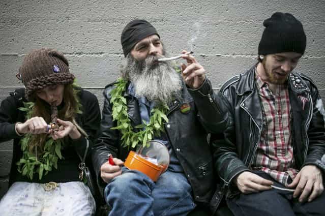 Hu Barney (C), smokes a joint during 420Fest at the Luxe Nightclub in Seattle, Washington April 20, 2013. In November 2012, voters approved legalizing the recreational use of marijuana in the state of Washington for adults over 21. (Photo by Nick Adams/Reuters)