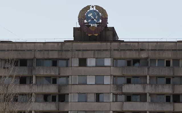 The coat of arms of the former Soviet Union is seen on the roof of a house in the abandoned city of Pripyat near Chernobyl nuclear power plant April 23, 2013. Ukraine will mark the 27th anniversary of the Chernobyl disaster, the world's worst civil nuclear accident, on April 26. (Photo by Gleb Garanich/Reuters)