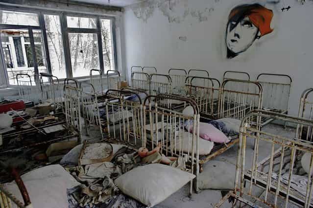 The remnants of beds are seen in an abandoned in a pre school in the deserted town of Pripyat on January 25, 2006 in Chernobyl, Ukraine. Prypyat and the surrounding area will not be safe for human habitation for several centuries. Scientists estimate that the most dangerous radioactive elements will take up to 900 years to decay sufficiently to render the area safe. (Photo by Daniel Berehulak/Getty Images)