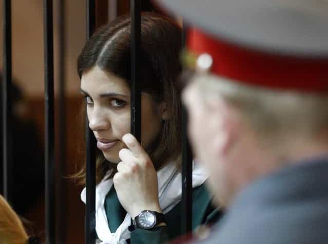 Pussy Riot band member Nadia Tolokonnikova looks out from a holding cell during a court hearing in the town of Zubova Polyana April 26, 2013. Tolokonnikova is appealing her conviction for hooliganism motivated by religious hate for which she is serving two years in a remote penal colony. (Photo by Mikhail Voskresensky/Reuters)
