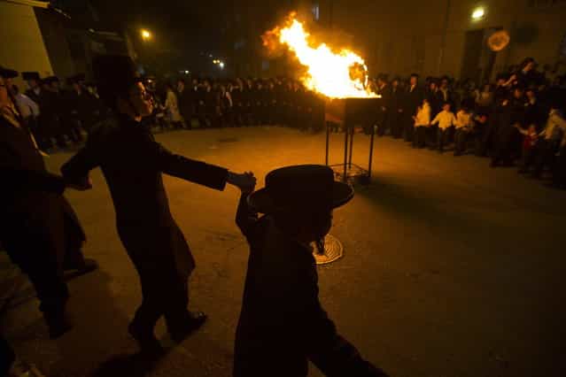 Ultra Orthodox Jews celebrate the Jewish holiday of Lag Ba-Omer in Jerusalem's Mea Shearim neighbourhood April 27, 2013. Israelis celebrate the Jewish holiday of Lag Ba-Omer, which marks the end of a plague in the Middle Ages that killed thousands of disciples of a revered rabbi in the holy land, by lighting bonfires across the country. (Photo by Ronen Zvulun/Reuters)