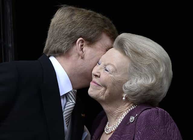 Princess Beatrix of Netherlands (R) embraces his son Dutch King Willem-Alexander at the balcony of the Royal Palace in Amsterdam April 30, 2013. The Netherlands is celebrating Queen's Day on Tuesday, which will also mark the abdication of Queen Beatrix and the investiture of her eldest son Willem-Alexander. (Photo by Dylan Martinez/Reuters)