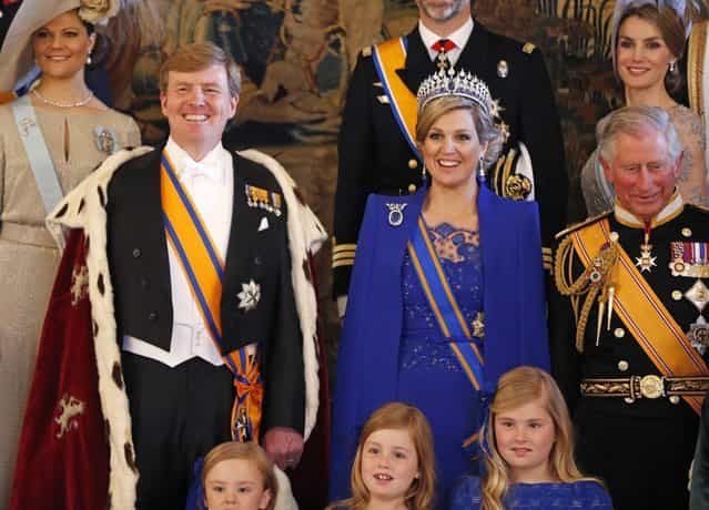 Dutch King Willem-Alexander his wife Queen Maxima accompanied by their daughters (bottom row R to L) Crown Princess Catharina-Amalia, Princess Ariane, Princess Alexia, Spain's Princess Letizia (top R) and Prince Charles of Wales (R) pose during a photocall at the royal palace in Amsterdam following the crowning cerimonies April 30, 2013. The Netherlands is celebrating Queen's Day on Tuesday, which also marks the abdication of Queen Beatrix and the investiture of her eldest son Willem-Alexander. (Photo by Bart Matt/Reuters)