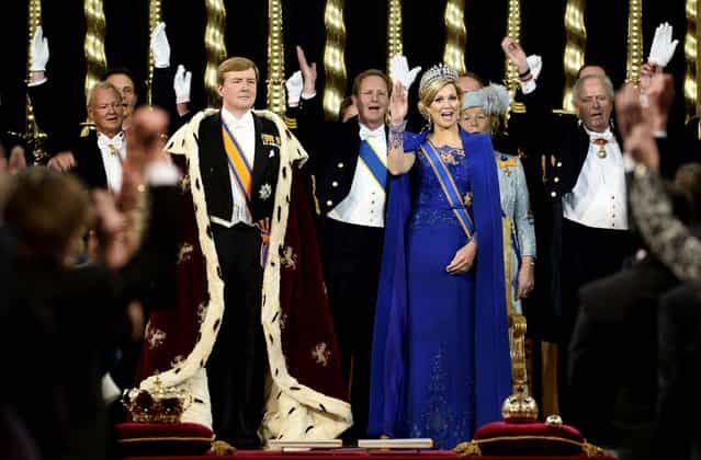 King Willem-Alexander is given three cheers by guests and his wife Queen Maxima inside the Nieuwe Kerk, or New Church, in Amsterdam, during his inauguration, on April 30, 2013. (Photo by Lex van Lieshout/Associated Press)