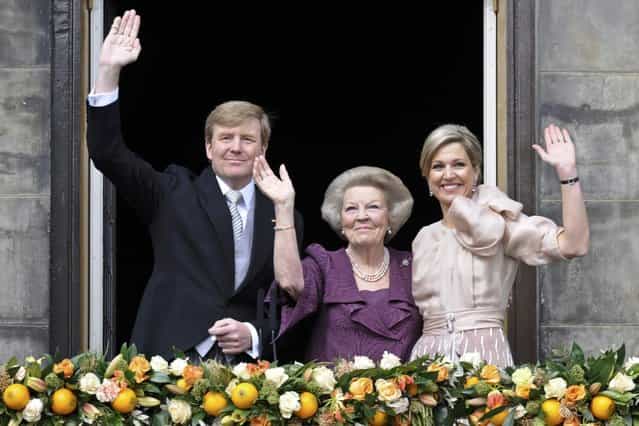 Princess Beatrix of Netherlands (C), her son, Dutch King Willem-Alexander (L) and his wife Queen Maxima wave to the crowd from the balcony of the Royal Palace in Amsterdam April 30, 2013. The Netherlands is celebrating Queen's Day on Tuesday, which will also mark the abdication of Queen Beatrix and the investiture of her eldest son Willem-Alexander. (Photo by Paul Vreeker/Reuters)