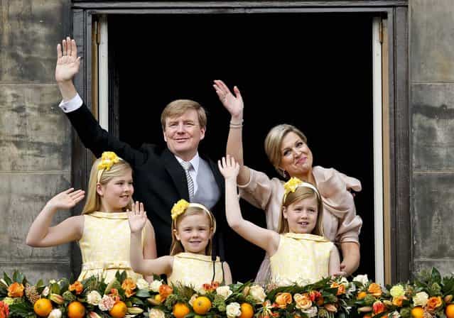 Dutch King Willem-Alexander and Queen Maxima appear on the balcony of the Royal Palace with their children in Amsterdam, The Netherlands, on April 30, 2013. (Photo by Daniel Ochoa de Olza/Associated Press)