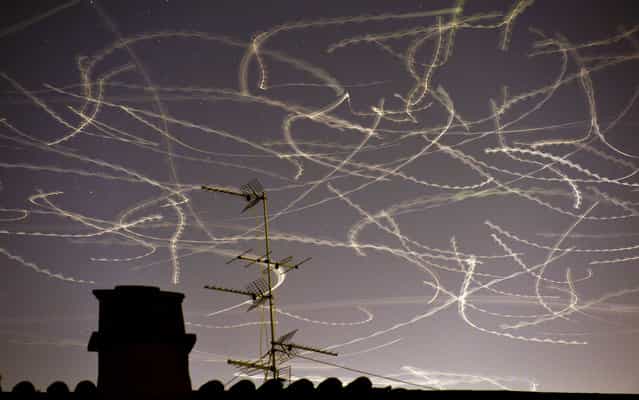 Seagulls fly in the sky over Rome on May 2, 2013 in this picture taken with a slow exposure. (Photo by Gabriel Bouys/AFP Photo)