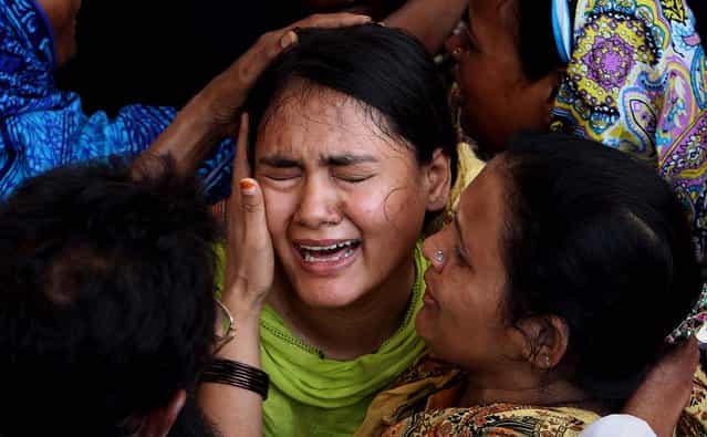 A woman mourns for her family member, who was killed in a bombing Saturday, during his funeral in Karachi, on May 5, 2013. Two blasts in Pakistan's southern city of Karachi killed three people on Saturday, near the office of a political party critical of the Taliban, heightening tensions ahead of the country's historic May 11 election. (Photo by Fareed Khan/Associated Press)