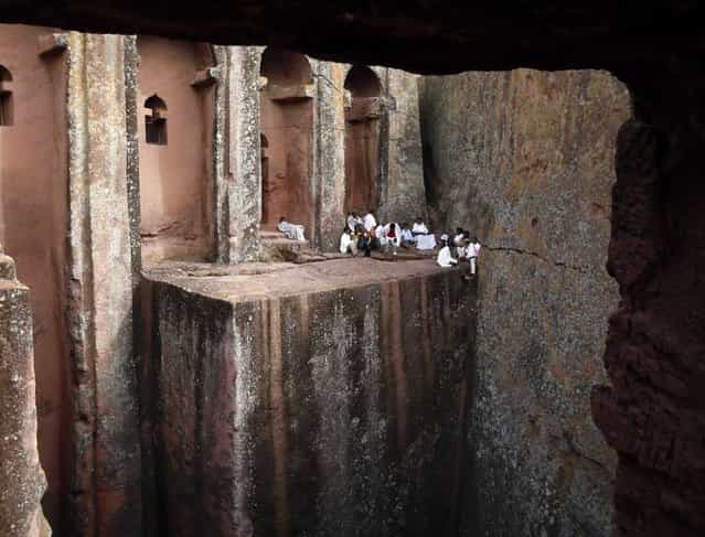 Orthodox Christians sit outside the famous monolithic rock-cut churches during a Good Friday celebration in Lalibela May 3, 2013. (Photo by Goran Tomasevic/Reuters)