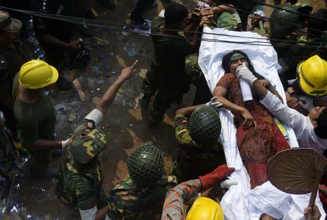 Rescue workers evacuate a survivor found in the rubble of the collapsed building in Savar, Bangladesh, on April 27, 2013. (Photo by Ismail Ferdous/Associated Press)