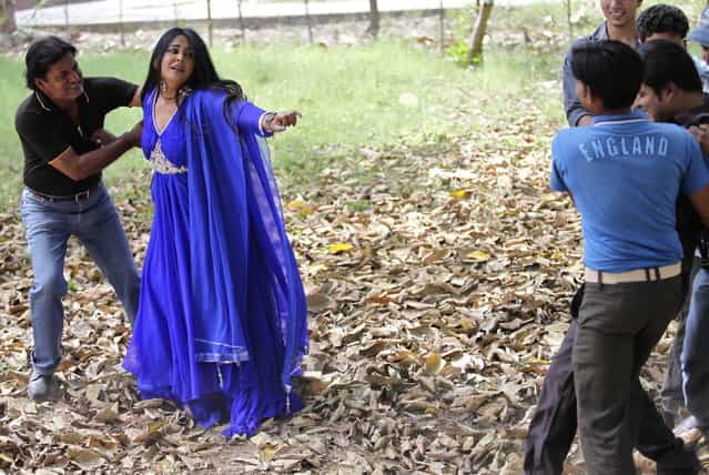 Actress Nainaa Jolly (2nd L) performs during the filming of a low budget Hindi movie in Meerut in the northern Indian state of Uttar Pradesh April 28, 2013. (Photo by Danish Siddiqui/Reuters)