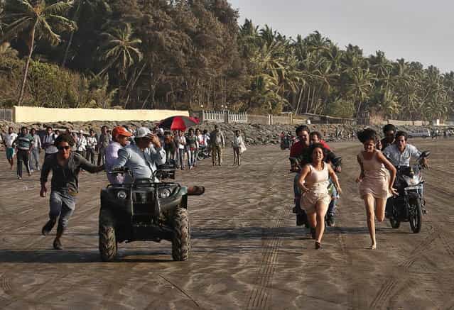Bollywood actress Chitrashi Rawat (3rd R) runs along a beach, as she is chased, during the shoot for the film [Black Home] on the outskirts of Mumbai April 26, 2013. (Photo by Danish Siddiqui/Reuters)
