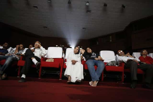 An audience watches a Hindi movie being screened during a festival celebrating 100 years of Indian cinema in New Delhi April 30, 2013. (Photo by Danish Siddiqui/Reuters)