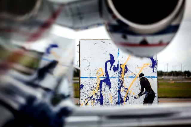 Von Anhalt paints in the jet wash. (Photo by Thomas Cordy/The Palm Beach Post)