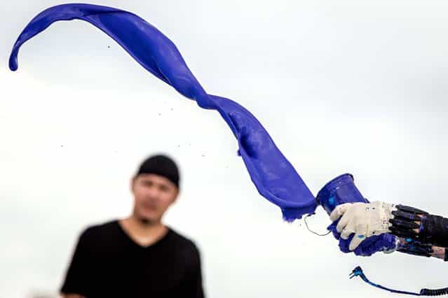 Princess Tarinan tosses a column of purple paint into the jet wash. (Photo by Thomas Cordy/The Palm Beach Post)