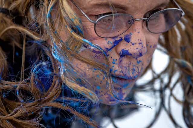 Von Anhalt's face bears the paint splatter from her jet wash painting technique. (Photo by Thomas Cordy/The Palm Beach Post)