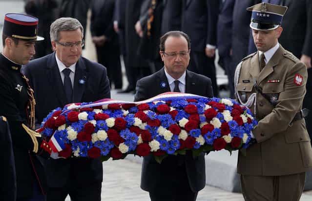 Polish President Bronislaw Komorowski and French President Francois Hollande, flanked by French and Polish soldiers, lay a wreath at the Tomb of the Unknown Soldier beneath the Arc de Triomphe in Paris during Wednesday's ceremony marking the 68th anniversary of the end of World War II in Europe. (Photo by Michel Euler/Associated Press)