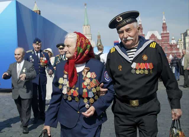 Russian WWII veterans walk after a Victory Day parade at Red Square on Thursday, May 9, 2013. President Vladimir Putin said at the annual military parade hat Russia will be a guarantor of world security. Putin's short speech came at the culmination of Victory Day, marking the defeat of Nazi Germany 68 years ago. It is Russia's most important secular holiday, honoring the huge military and civilian losses of World War II and showing off the country's modern arsenal. (Photo by Ivan Sekretarev/AP Photo)