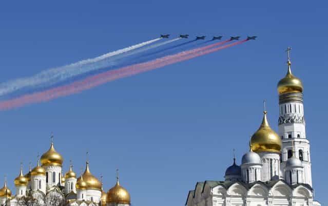 Military jets fly over an Orthodox Christian church during a rehearsal for the Victory Day parade in Moscow, May 7, 2013. Russia marks victory over Nazi Germany in World War Two every year on May 9. (Photo by Mikhail Voskresensky/Reuters)