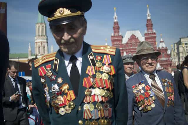 Russian WWII veterans walk after the Victory Day parade at Red Square on Thursday, May 9, 2013. Russian President Vladimir Putin said at the annual military parade hat Russia will be a guarantor of world security. Putin's short speech came at the culmination of Victory Day, marking the defeat of Nazi Germany 68 years ago. It is Russia's most important secular holiday, honoring the huge military and civilian losses of World War II and showing off the country's modern arsenal. (Photo by Ivan Sekretarev/AP Photo)