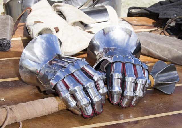 Metal gloves lay on a table during the [Battle of Nations] in Aigues-Mortes, southern France, Friday, May 10, 2013 where Middle Ages fans attend the historical medieval battle competition. The championship will be attended by 22 national teams, which is twice the number it was last year. The battle lasts until May 12. (Photo by Philippe Farjon/AP Photo)