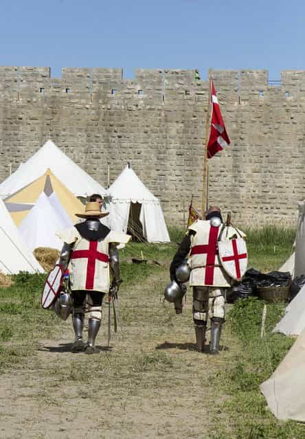 Members of UK team walk back to their camp during the [Battle of Nations] in Aigues-Mortes, southern France, Friday, May 10, 2013 where Middle Ages fans attend the historical medieval battle competition. The championship will be attended by 22 national teams, which is twice the number it was last year. The battle lasts until May 12. (Photo by Philippe Farjon/AP Photo)