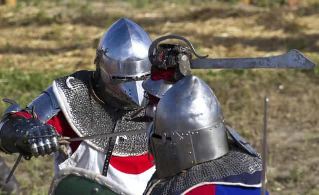 A member of team Japan, left, fights against a Czech Republic contestant during the [Battle of Nations] in Aigues-Mortes, southern France, Friday, May 10, 2013 where Middle Ages fans attend the historical medieval battle competition. The championship will be attended by 22 national teams, which is twice the number it was last year. The battle lasts until May 12.(Photo by Philippe Farjon/AP Photo)
