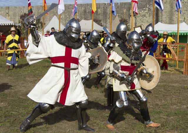 Members of UK team fight during the [Battle of Nations] in Aigues-Mortes, southern France, Friday, May 10, 2013 where Middle Ages fans attend the historical medieval battle competition. The championship will be attended by 22 national teams, which is twice the number it was last year. The battle lasts until May 12.(Photo by Philippe Farjon/AP Photo)