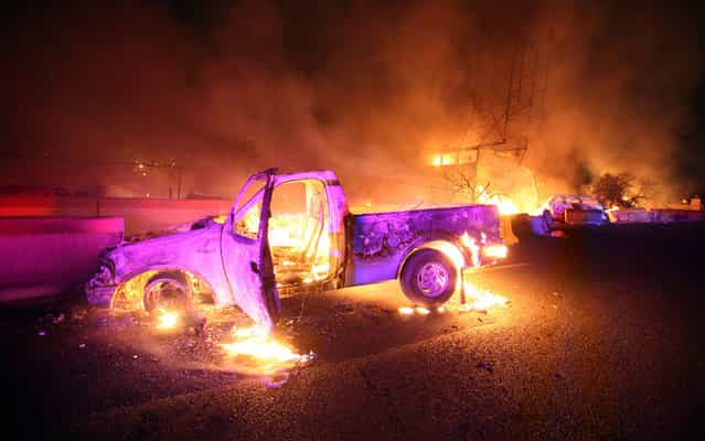 Burned cars are pictured in a highway in Ecatepec near Mexico city, on May 7, 2013. A gas tanker exploded in a Mexico City suburb on Tuesday, killing at least 18 people and damaging several homes and cars, an official said. (Photo by Victor Rojas/AFP Photo)