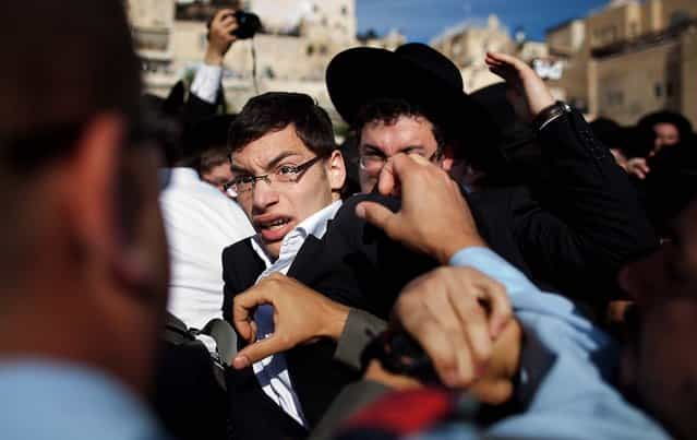 Ultra-Orthodox protesters clash with Israeli police officers during the prayer service held by the [Women Of The Wall], on May 10, 2013. (Photo by Uriel Sinai/Getty Images)