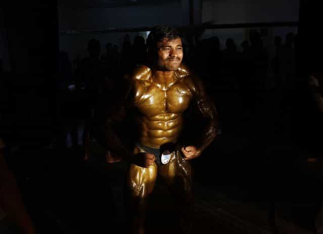 A competitor flexes his muscles backstage during the 53rd Mr. India bodybuilding competition in the southern Indian city of Chennai May 8, 2013. Around 300 bodybuilders from across India participated in the competition on Wednesday. (Photo by Reuters/Babu)