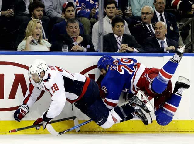 Troy Brouwer of the Washington Capitals and the Rangers' Ryane Clowe go airborne after colliding in the third period of Game 4 of their first-round Stanley Cup playoff series in New York, on May 8, 2013. The Rangers won 4-3. (Photo by Kathy Willens/Associated Press)