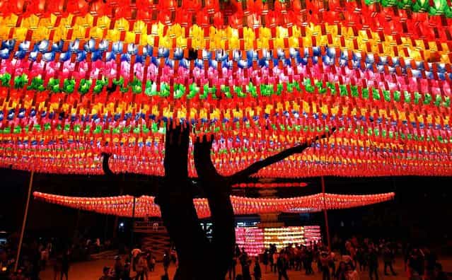 People walk under colorful lanterns as they celebrate the forthcoming birthday of Buddha at the Chogey temple in Seoul. (Photo by Chung Sung-Jun/Getty Images)