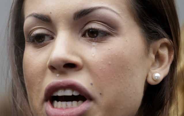 A tear rolls down the cheek of Karima el-Mahroug, also known as Ruby, a Moroccan woman at the center of ex-Premier Silvio Berlusconi's sex-for-hire trial, as she reads a statement to reporters during a protest outside the court house, in Milan, Italy, Thursday, April 4, 2013. The Moroccan woman at the center of ex-Premier Silvio Berlusconi's sex-for-hire trial has denounced what she says is psychological warfare being waged against her by Italian prosecutors. Ruby, read out a lengthy statement Thursday to a gaggle of reporters in front of Milan's courthouse denying she was a prostitute and insisting that prosecutors hear her side of the story. (Photo by Luca Bruno/AP Photo)