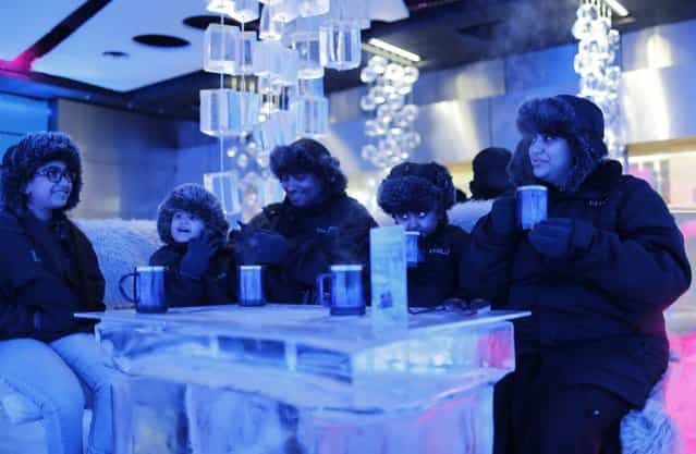 A Saudi Arabian family drinks hot chocolate at Chillout cafe in Dubai May 12, 2013. (Photo by Ahmed Jadallah/Reuters)