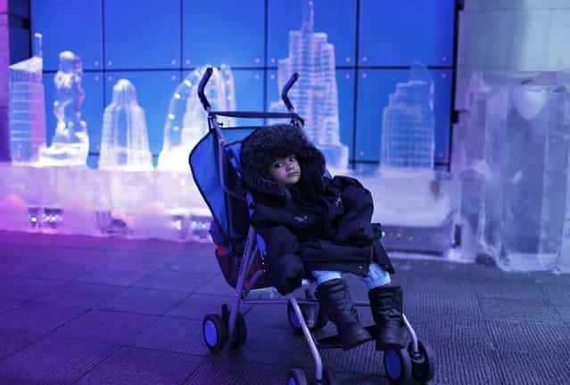 A toddler sits in his stroller while his parents tour the insides of the Chillout cafe in Dubai May 12, 2013. (Photo by Ahmed Jadallah/Reuters)