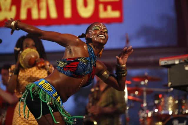 A fela dancer, accompanying Nigerian musician Tony Allen's band with its Afro-beat rhythms, performs during their set on stage at the St Lucia Jazz and Arts Festival at Pigeon Island National Landmark May 11, 2013. (Photo by Andrea De Silva/Reuters)