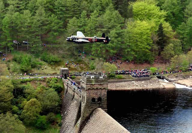 A Lancaster bomber during the Battle of Britain Memorial Flight performs a flypast over the Derwent Reservoir as part of a series of events to commemorate 70th anniversary of the Dambusters raid, May 16, 2013. (Photo by Rui Vieira/PA Wire)