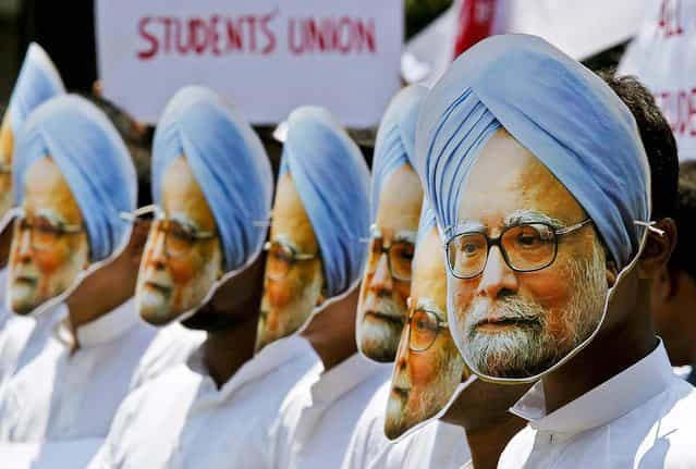 Activists wear masks of Indian Prime Minister Manmohan Singh during a protest against Singh, claiming he has not done anything for the state of Assam, where he was nominated from, in Gauhati, India, on May 15, 2013. (Photo by Anupam Nath/Associated Press)