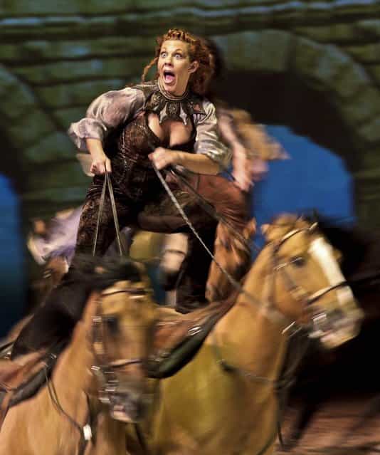 Fairland Ferguson rides while standing on the backs of a pair of horses during a dress rehearsal for the show [Cavalia] in Sydney, on May 13, 2013. Cavalia, a mix of daredevil horse riding and acrobatics, opens in Sydney on May 15. (Photo by Rick Rycroft/Associated Press)