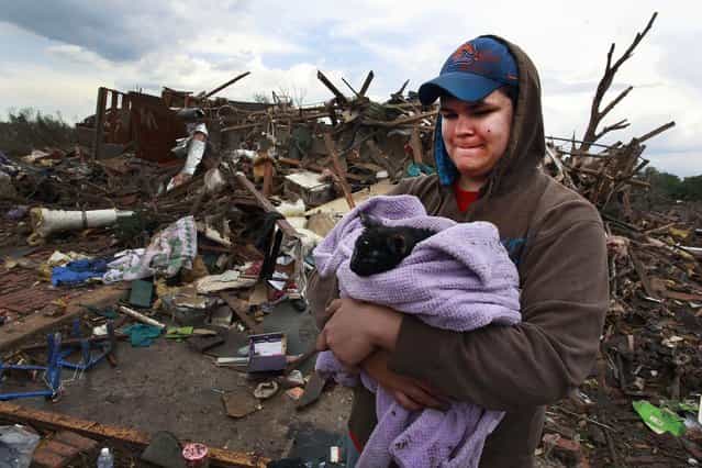 Austin Brock holdshis cat Tutti, shortly after the animal was retrieved from the rubble of Brock's home in Moore on Tuesday. (Photo by Brennan Linsley/Associated Press)