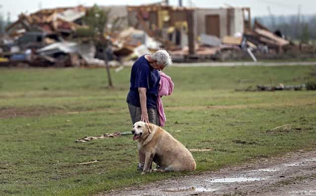 Kay Taylor stands with her dog Bailey in front of her destroyed house in Oklahoma City on Monday. (Photo by Chris Landsberger/The Oklahoman)