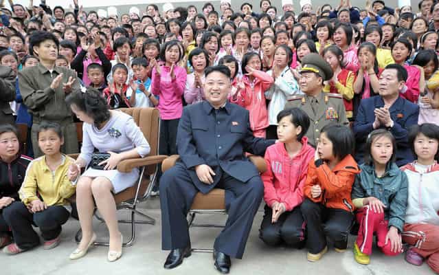 North Korean leader Kim Jong-un and his wife Ri Sol-ju sit have clearly stirred the emotions of the crowd during a visit to the Pyongyang Myohyangsan Children's Camp in North Phyongan, on May 20, 2013. (Photo by Reuters/KCNA)