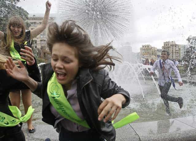 Secondary school graduates play in a fountain as they celebrate the last day of school in Kiev May 24, 2013. Students across Ukraine celebrated the end of the academic year on Friday, traditionally called the [last bell]. (Photo by Gleb Garanich/Reuters)