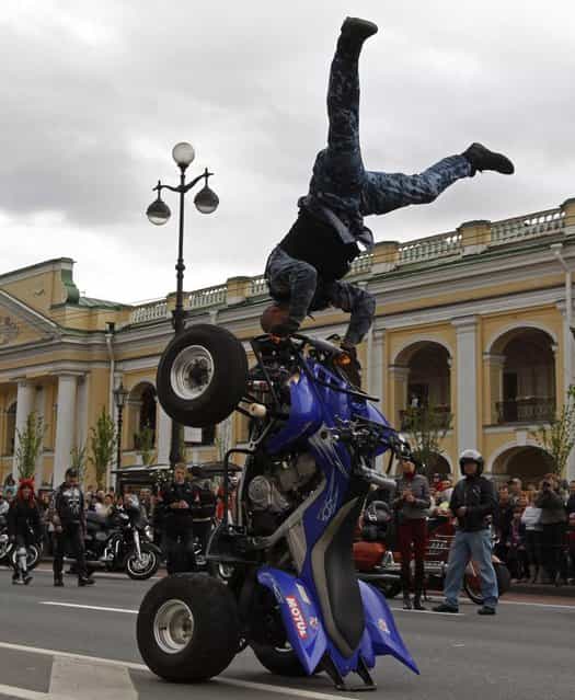 A biker demonstrates his skills on Nevsky Avenue in St. Petersburg, Russia, on May 26, 2013. Citizens of St. Petersburg on Sunday celebrated the 310th anniversary of the city’s foundation by Russian Tsar Peter the Great. (Photo by Alexander Demianchuk/Reuters)